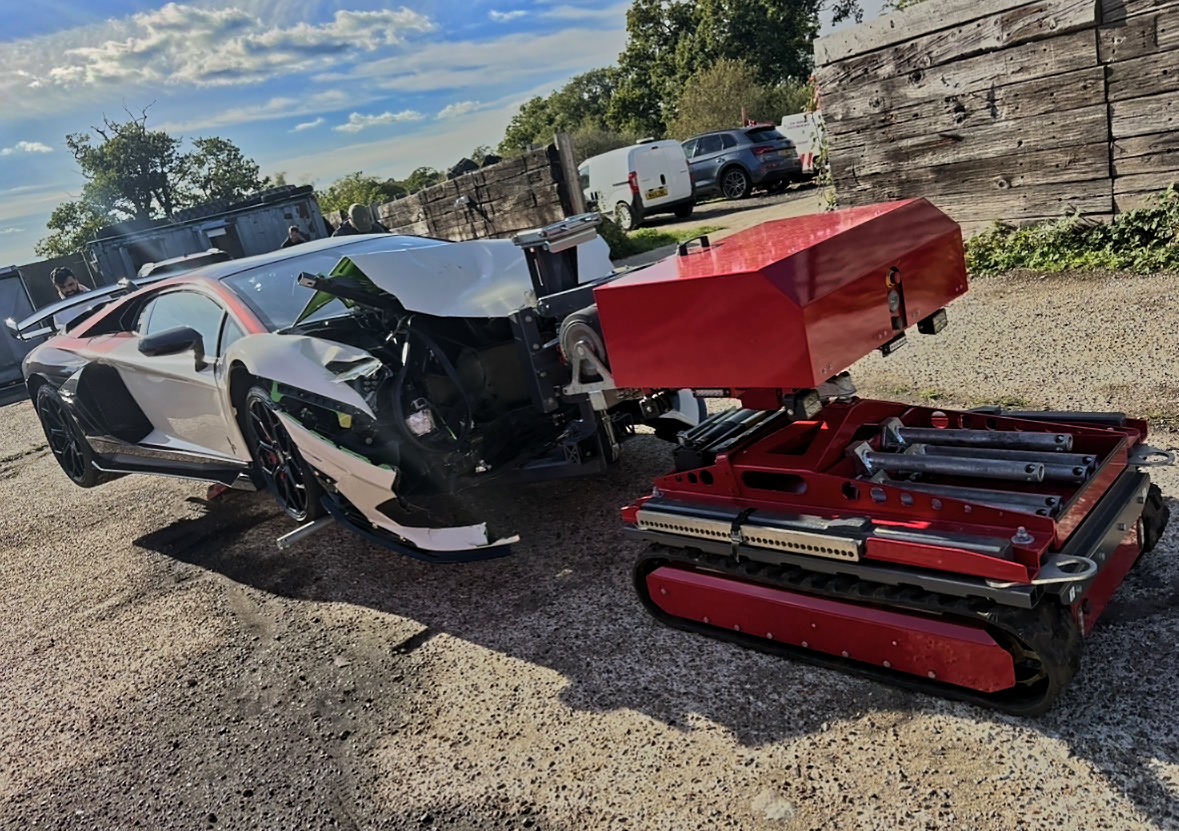 First Mover robotic unit recovering an accident damaged car
